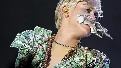 Майли Сайрус съела деньги прямо на сцене